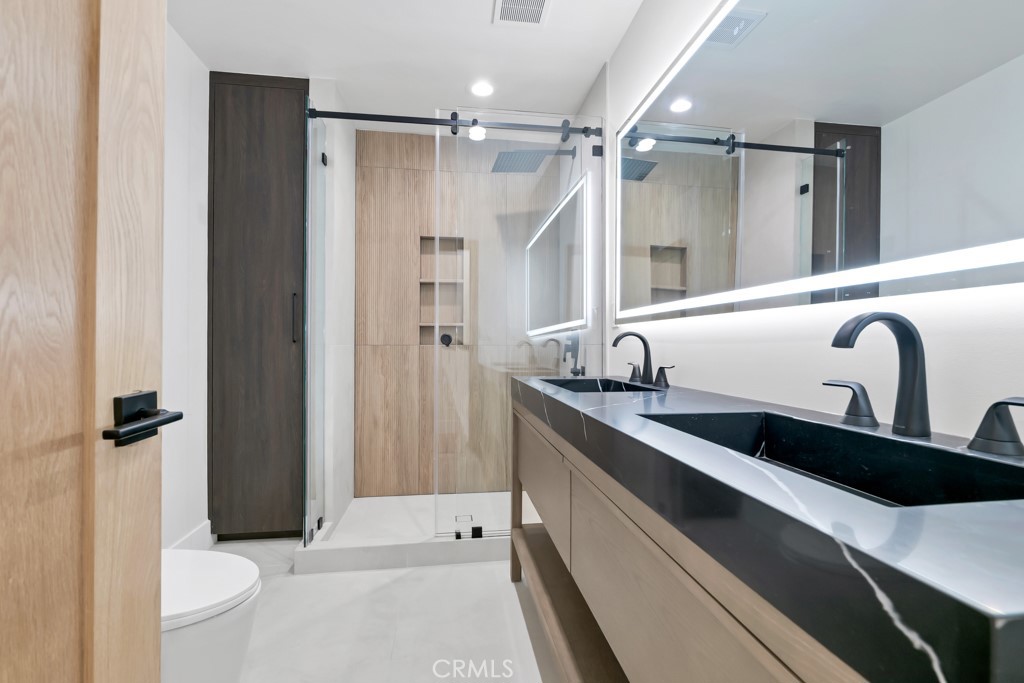 6156 Colbath Avenue Valley Glen, CA 91401 - Photo 19 of 62 a bathroom with a double vanity sink toilet and shower