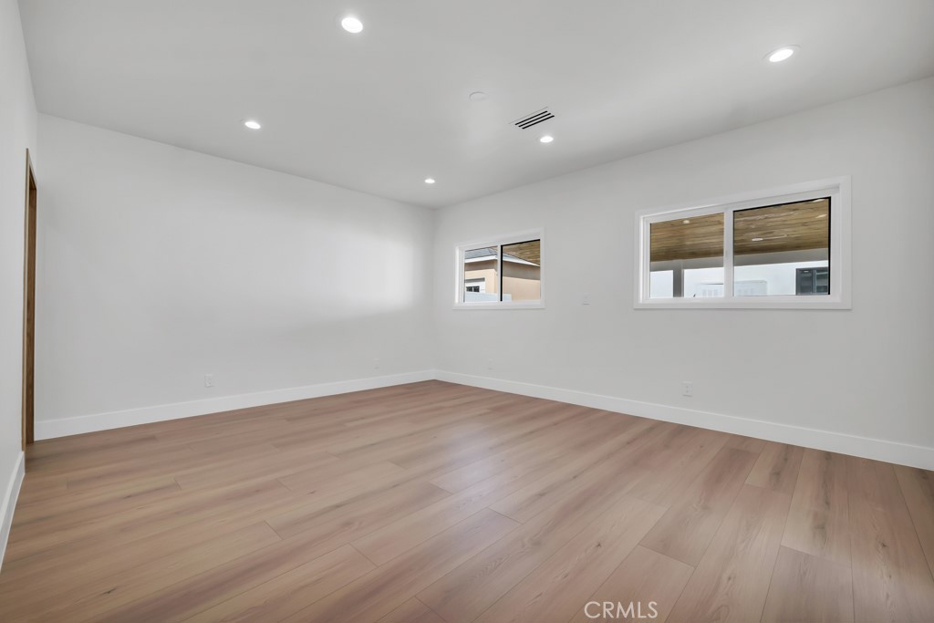 6156 Colbath Avenue Valley Glen, CA 91401 - Photo 22 of 62 an empty room with wooden floor and windows