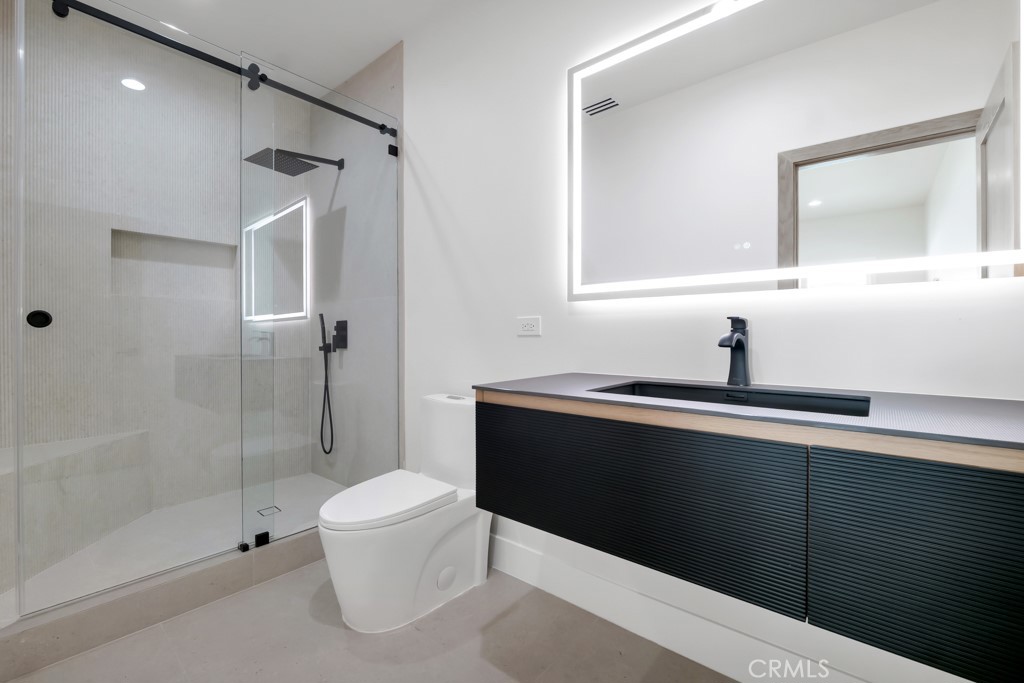 6156 Colbath Avenue Valley Glen, CA 91401 - Photo 24 of 62 a bathroom with a sink a toilet and shower