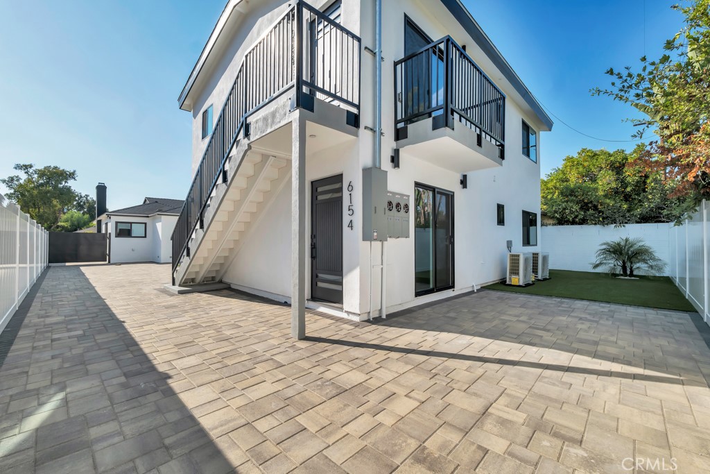 6156 Colbath Avenue Valley Glen, CA 91401 - Photo 31 of 62 a view of a white house with a small yard and potted plants