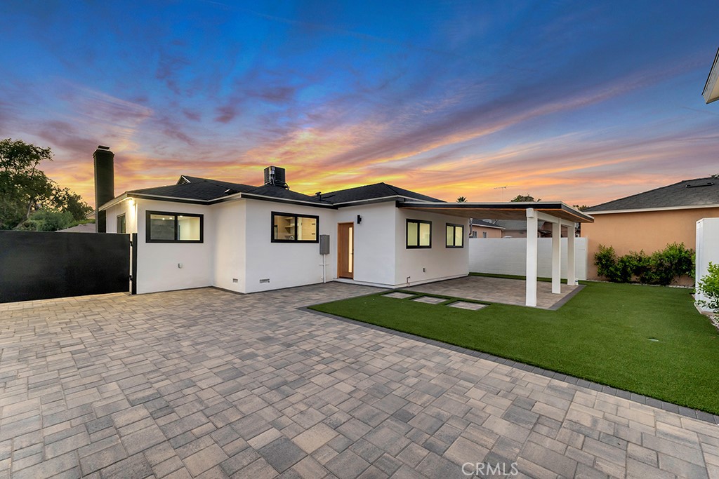6156 Colbath Avenue Valley Glen, CA 91401 - Photo 4 of 62 a view of a white house with a yard and a large tree