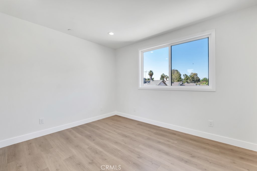 6156 Colbath Avenue Valley Glen, CA 91401 - Photo 43 of 62 a view of empty room with wooden floor and fan