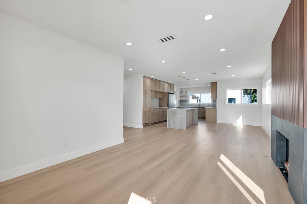6156 Colbath Avenue Valley Glen, CA 91401 - Photo 6 of 62 a view of a big room with wooden floor and a kitchen