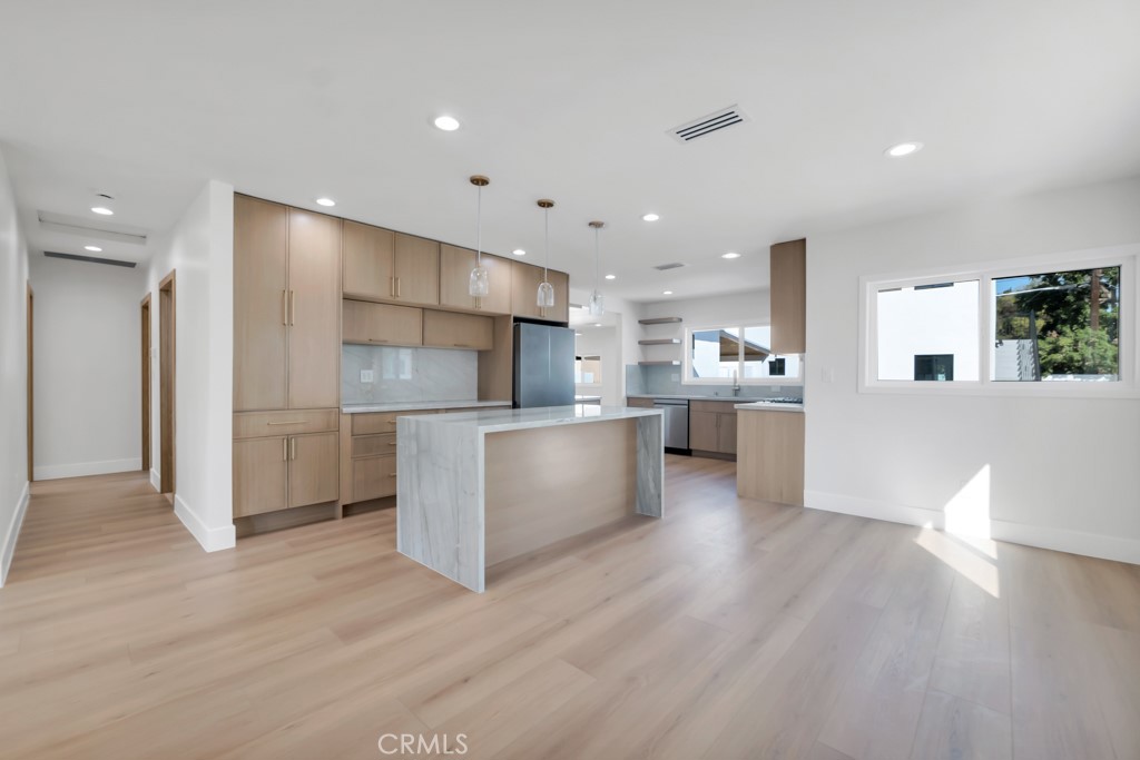 6156 Colbath Avenue Valley Glen, CA 91401 - Photo 9 of 62 a kitchen with stainless steel appliances refrigerator cabinets and wooden floor