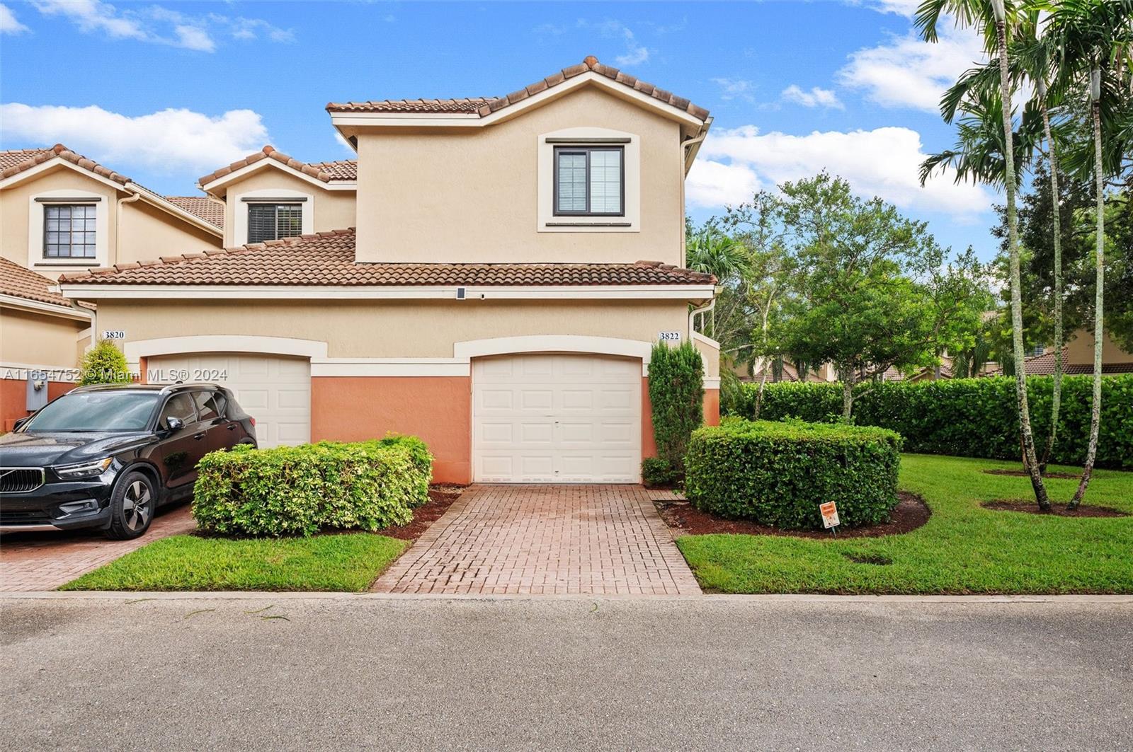 3822 Tree Top Drive Weston, FL 33332 - Photo 1 of 37 a front view of a house with a yard and garage