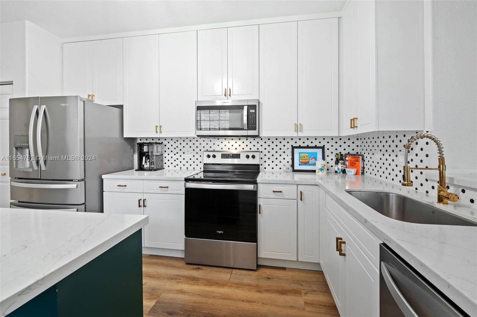 3822 Tree Top Drive Weston, FL 33332 - Photo 12 of 37 a kitchen with a sink stove and refrigerator