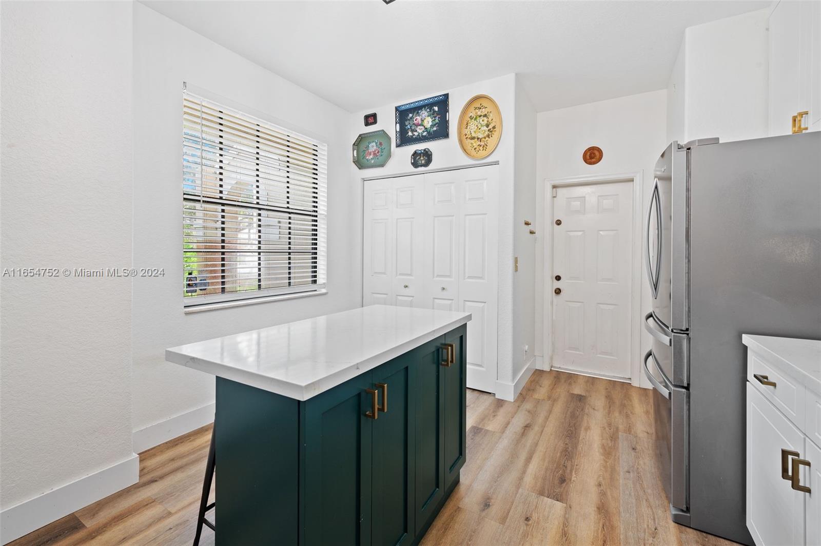 3822 Tree Top Drive Weston, FL 33332 - Photo 13 of 37 a kitchen with a refrigerator and a sink