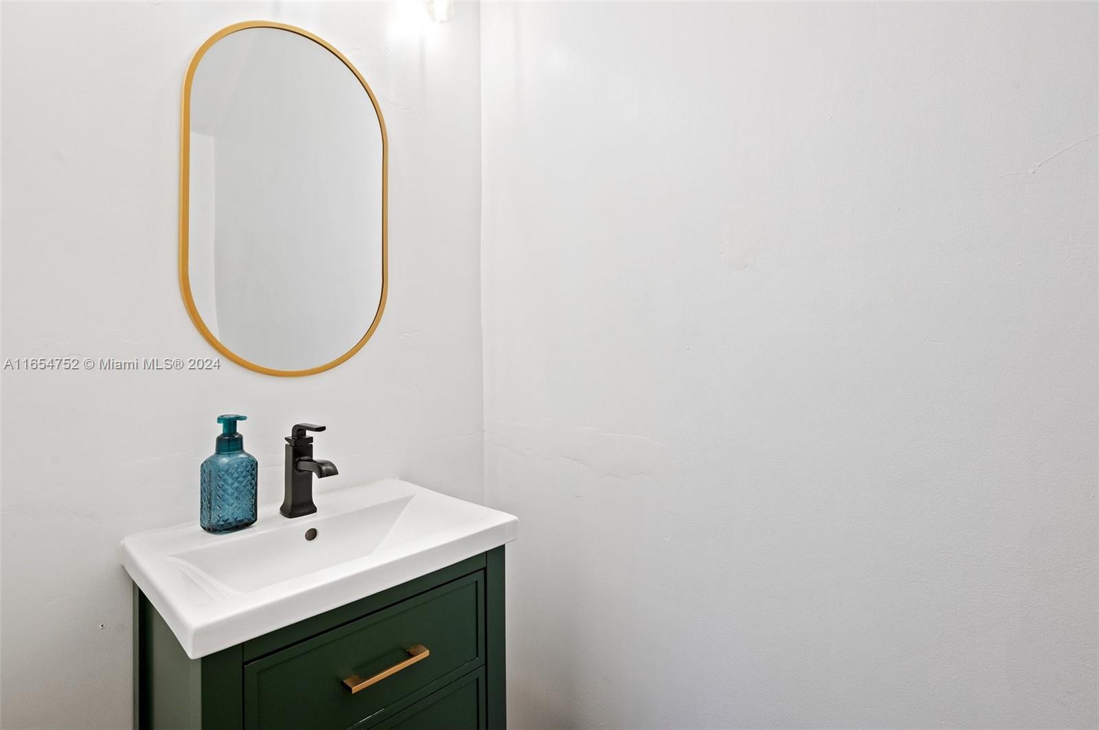 3822 Tree Top Drive Weston, FL 33332 - Photo 16 of 37 a bathroom with a sink and a mirror