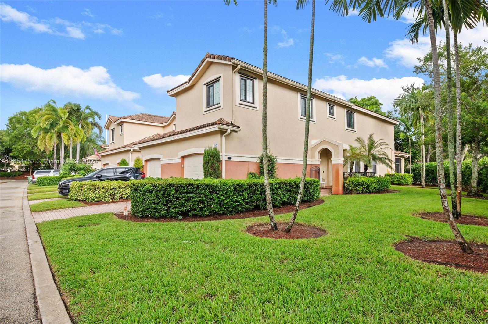 3822 Tree Top Drive Weston, FL 33332 - Photo 2 of 37 a front view of a house with a yard