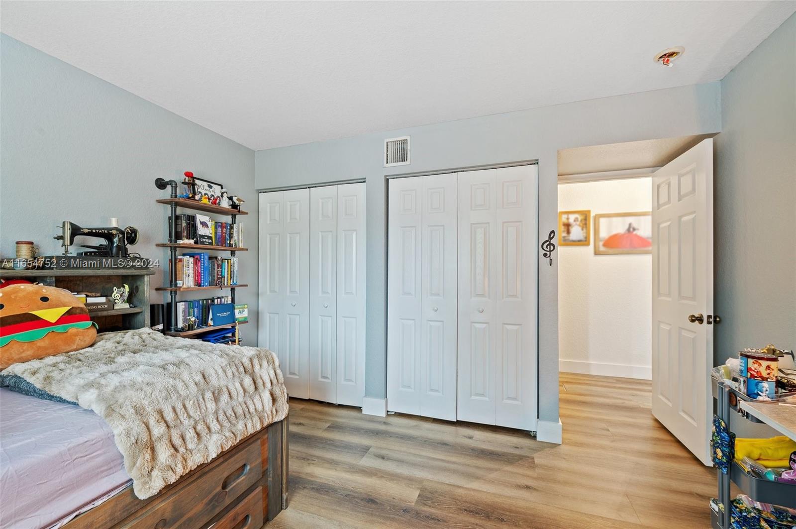 3822 Tree Top Drive Weston, FL 33332 - Photo 26 of 37 a bedroom with a bed and a wooden floor