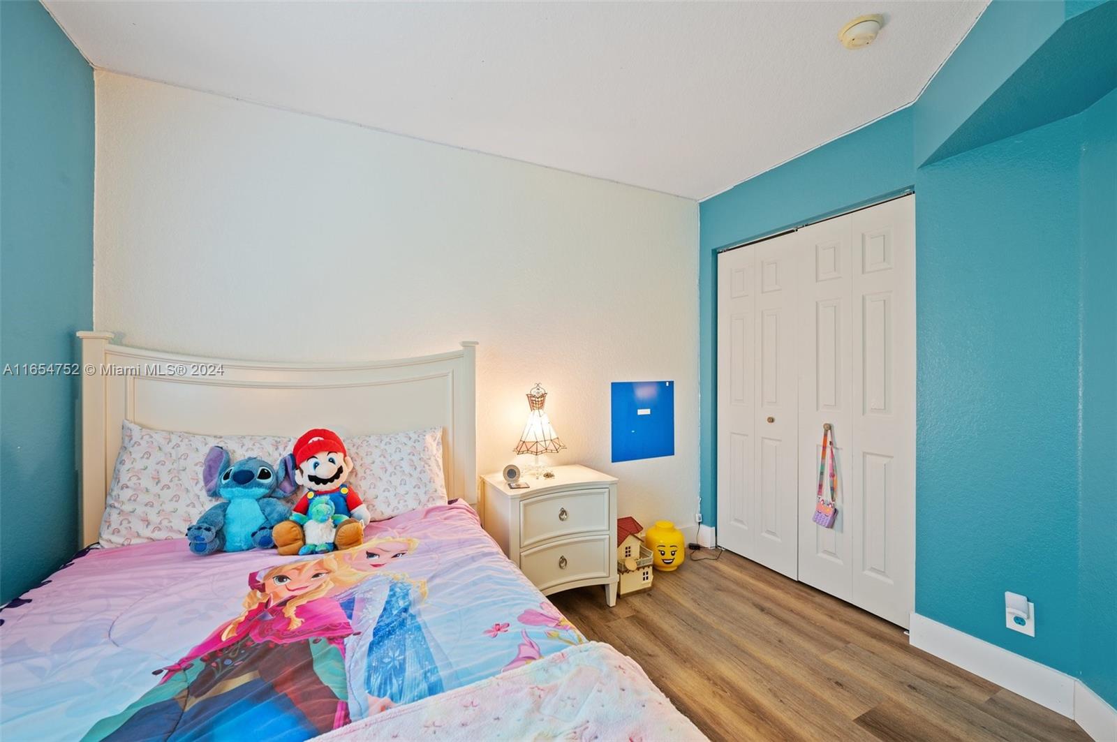 3822 Tree Top Drive Weston, FL 33332 - Photo 28 of 37 a bedroom with a bed and wooden floor