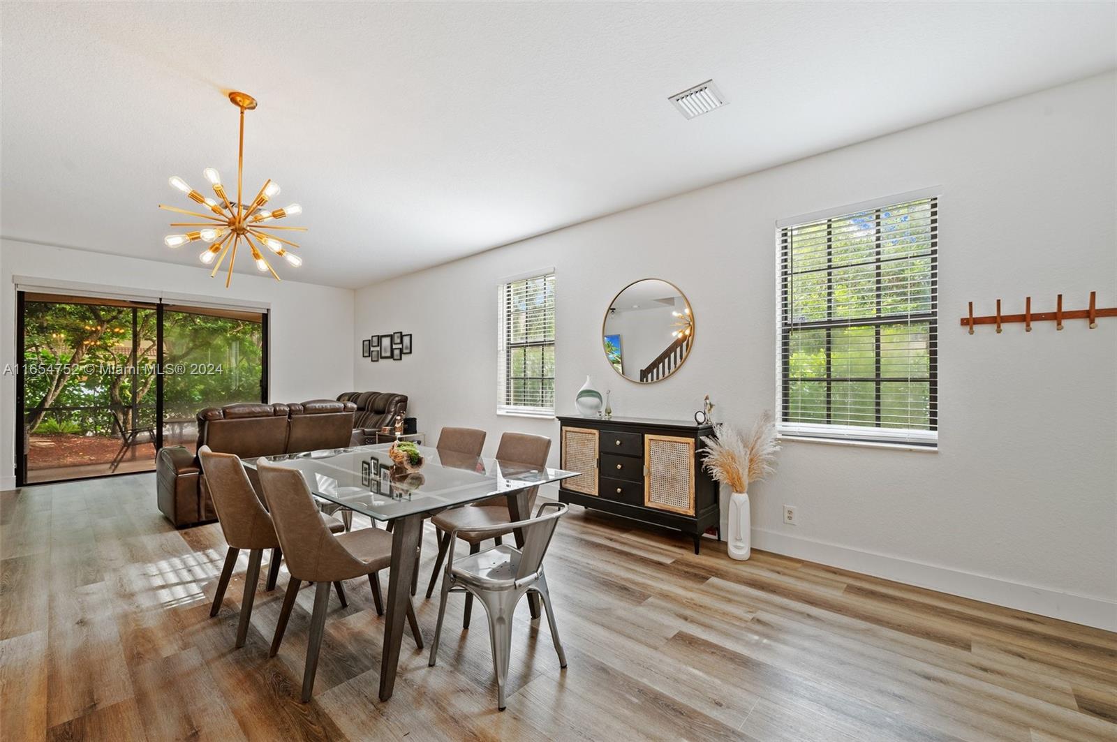 3822 Tree Top Drive Weston, FL 33332 - Photo 4 of 37 a view of a dining room with furniture a chandelier and wooden floor