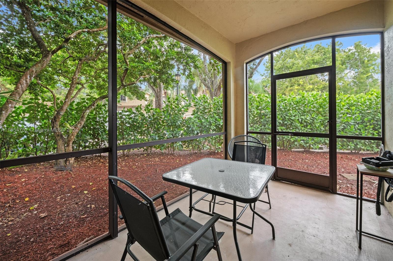 3822 Tree Top Drive Weston, FL 33332 - Photo 8 of 37 a view of a porch with furniture and a yard