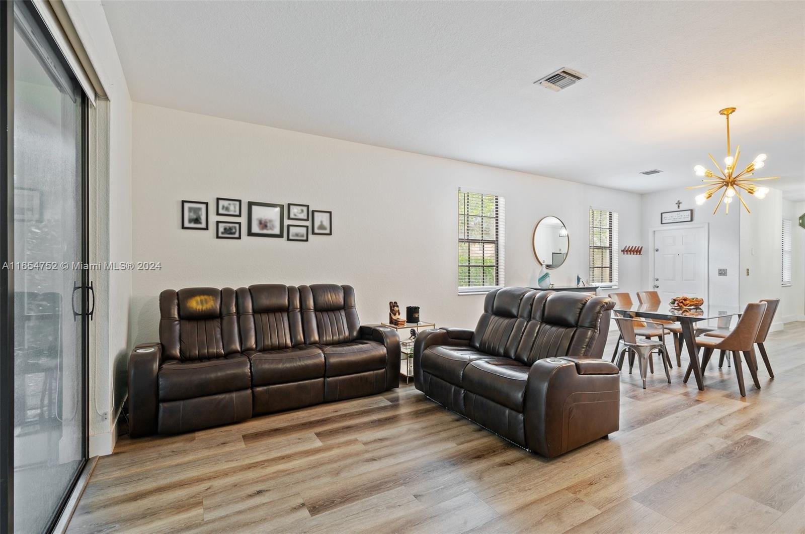 3822 Tree Top Drive Weston, FL 33332 - Photo 10 of 37 a living room with furniture and a chandelier
