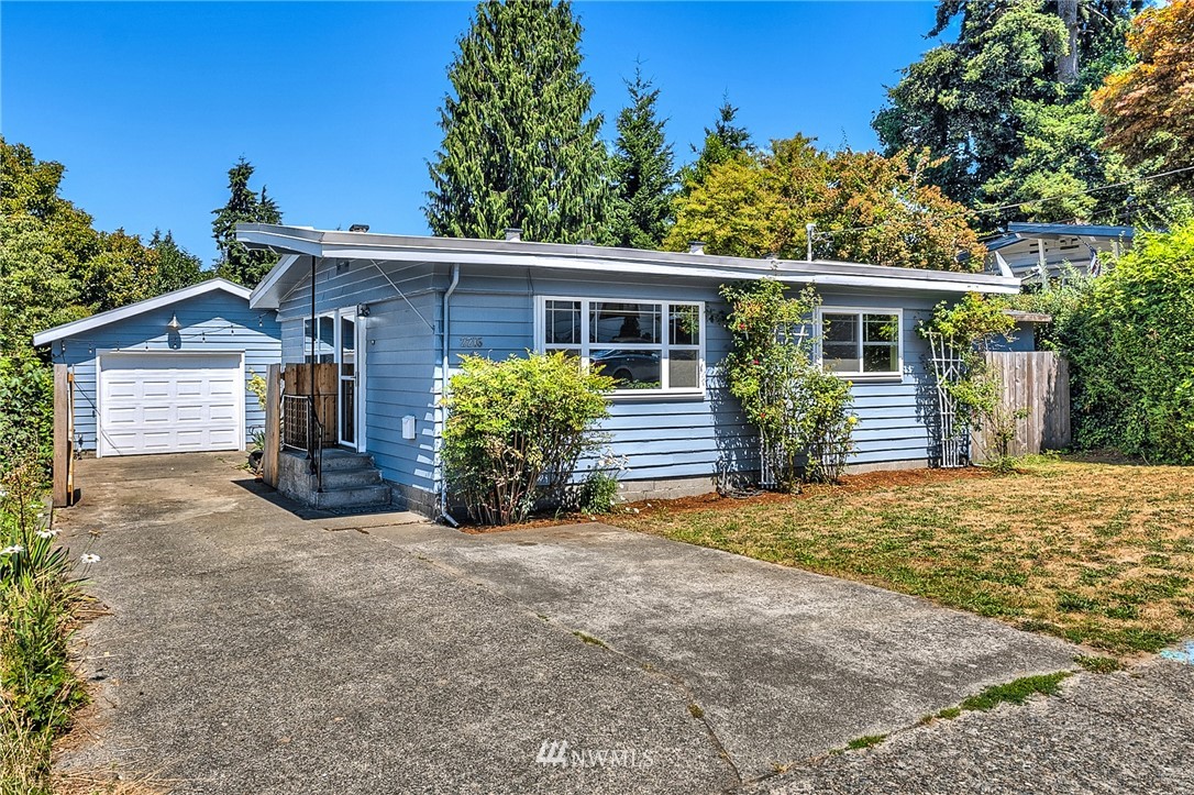 2216 Northeast 8th Place Renton, WA 98056 - Photo 1 of 24 front view of a house with a yard