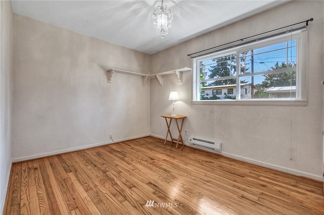 2216 Northeast 8th Place Renton, WA 98056 - Photo 16 of 24 a view of an empty room with a window and wooden floor