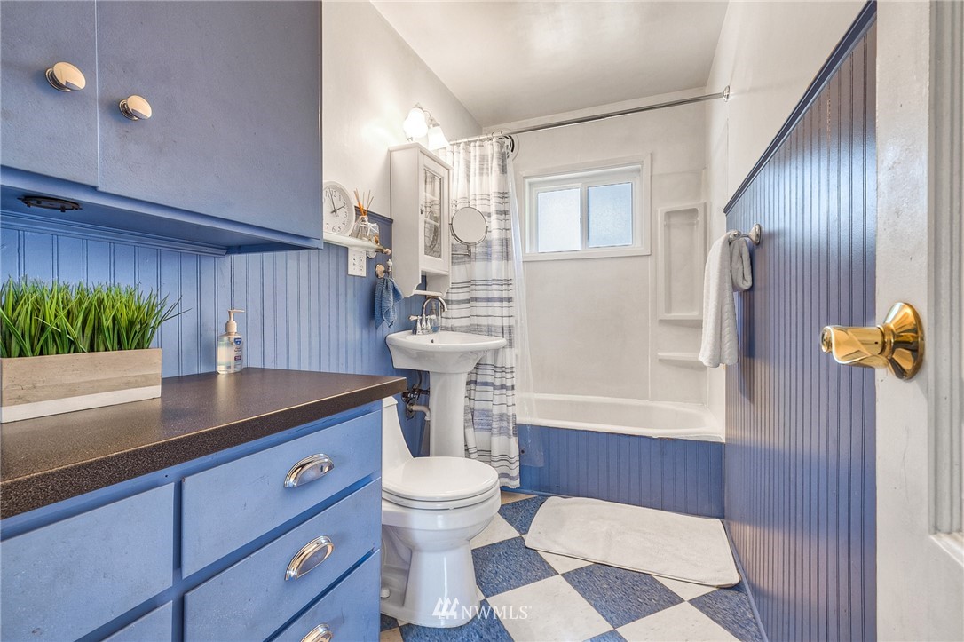 2216 Northeast 8th Place Renton, WA 98056 - Photo 17 of 24 a bathroom with a sink a toilet and shower