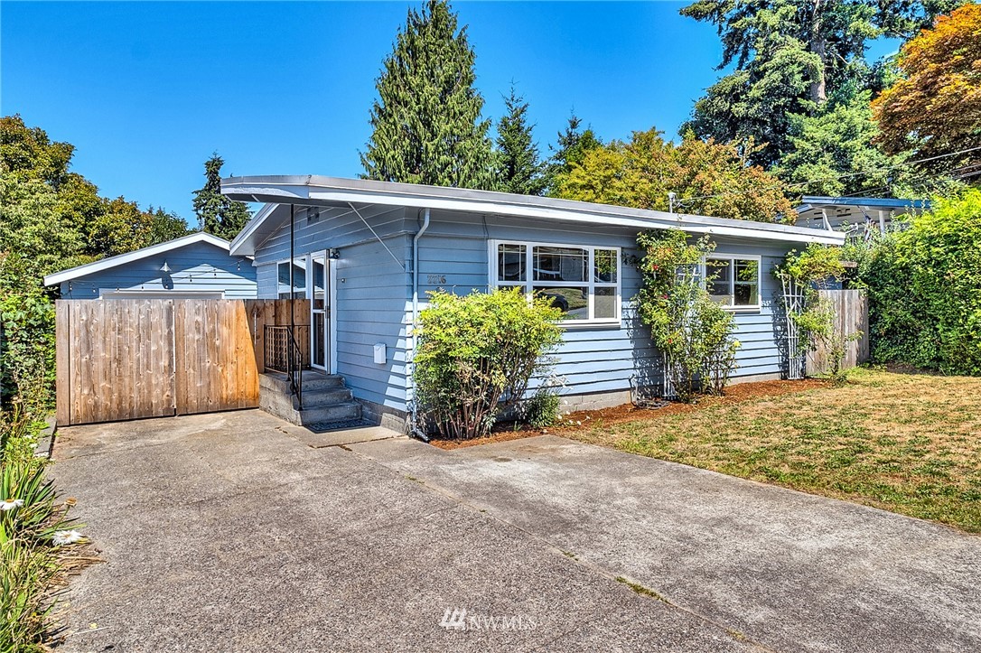 2216 Northeast 8th Place Renton, WA 98056 - Photo 21 of 24 a view of a house with a yard and potted plants