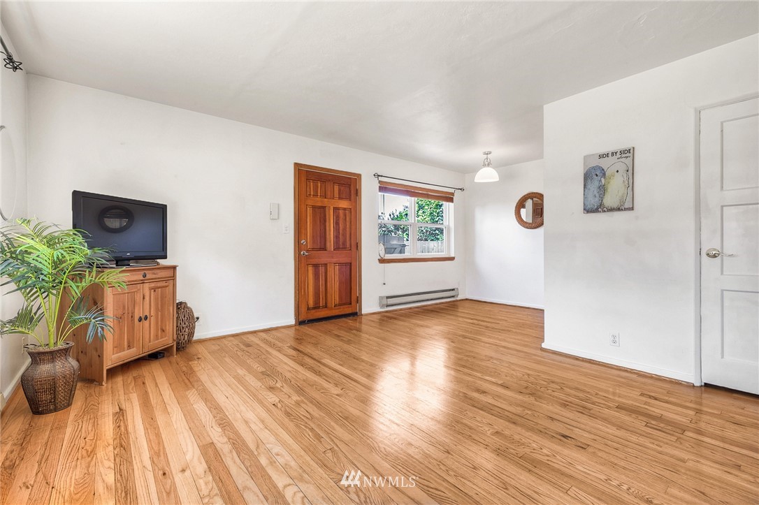 2216 Northeast 8th Place Renton, WA 98056 - Photo 7 of 24 a view of livingroom with hardwood floor and a window