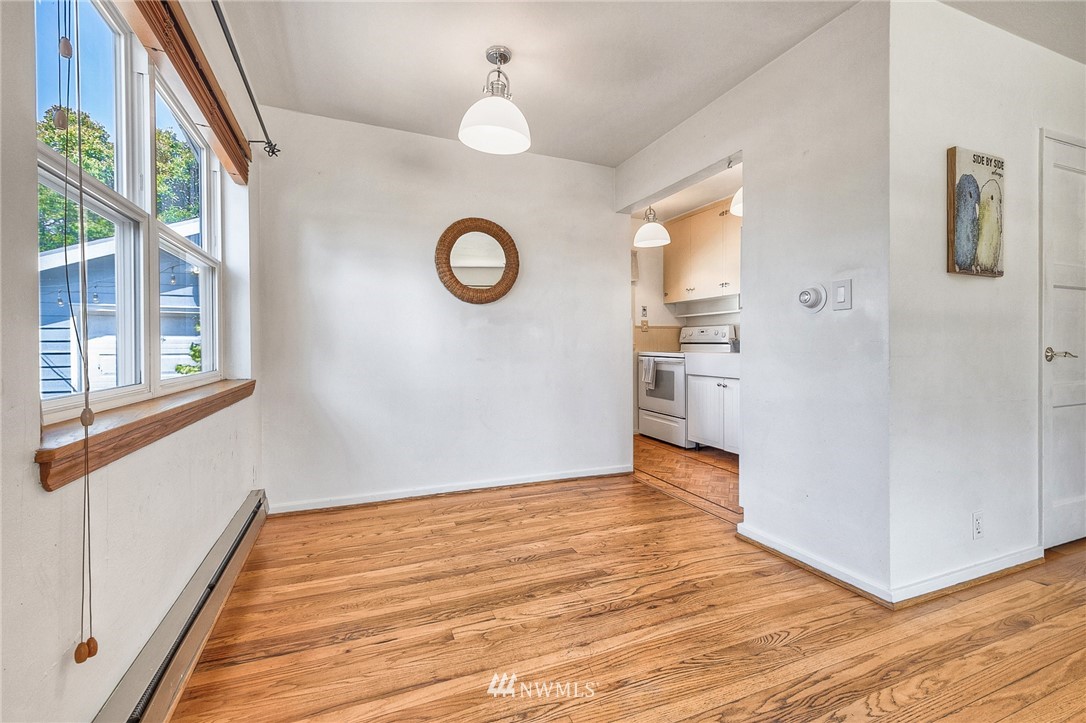 2216 Northeast 8th Place Renton, WA 98056 - Photo 9 of 24 a view of an empty room with wooden floor and a window