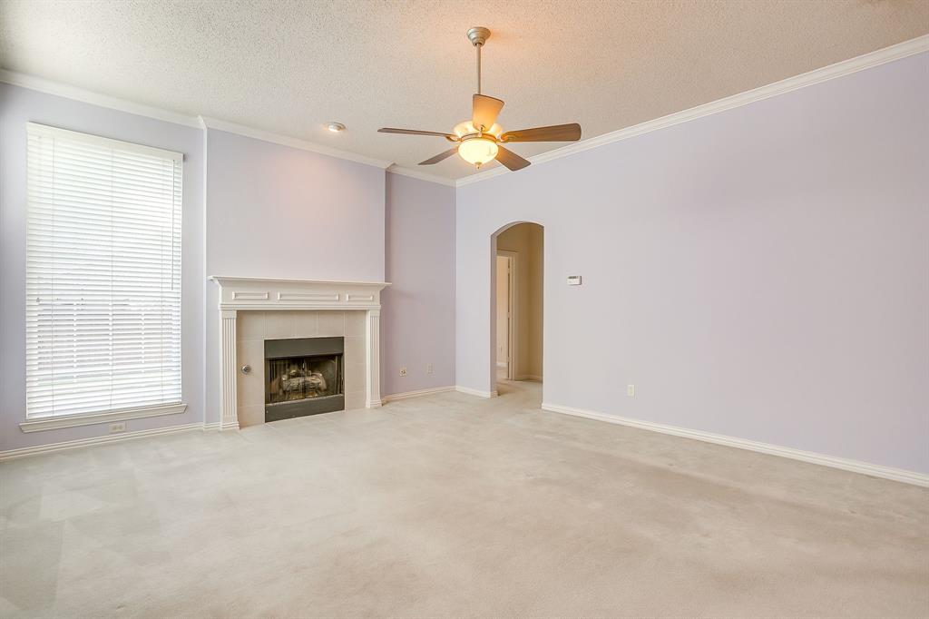 8105 Hosta Way Fort Worth, TX 76123 - Photo 15 of 33 a view of empty room with a fireplace and a fan
