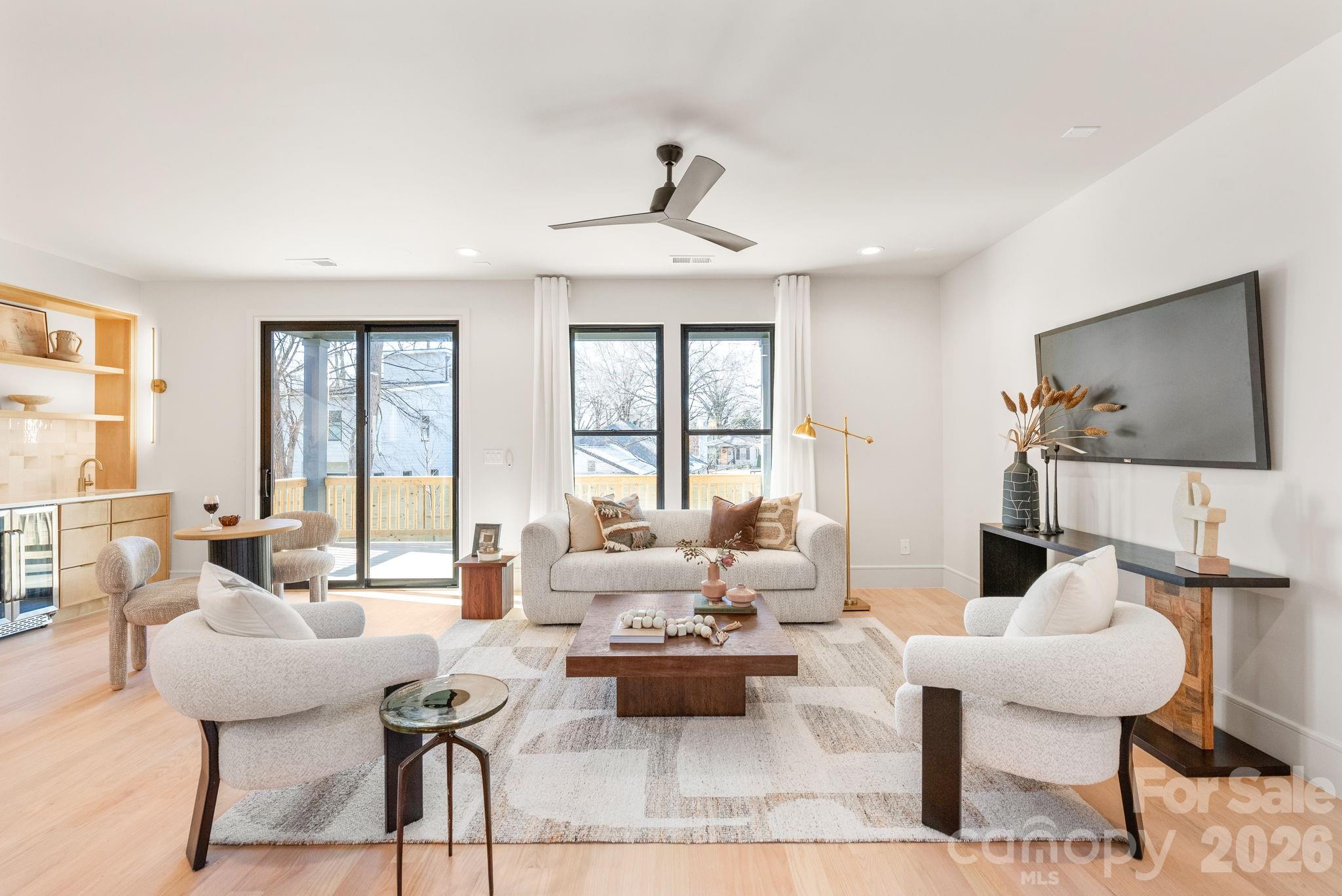 1637 Umstead Street Charlotte, NC 28205 - Photo 16 of 48 a living room with furniture a flat screen tv and a large window