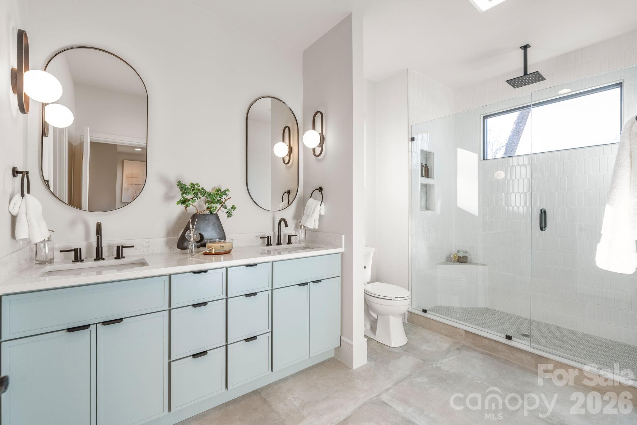 1637 Umstead Street Charlotte, NC 28205 - Photo 31 of 48 a bathroom with a double vanity sink toilet and shower