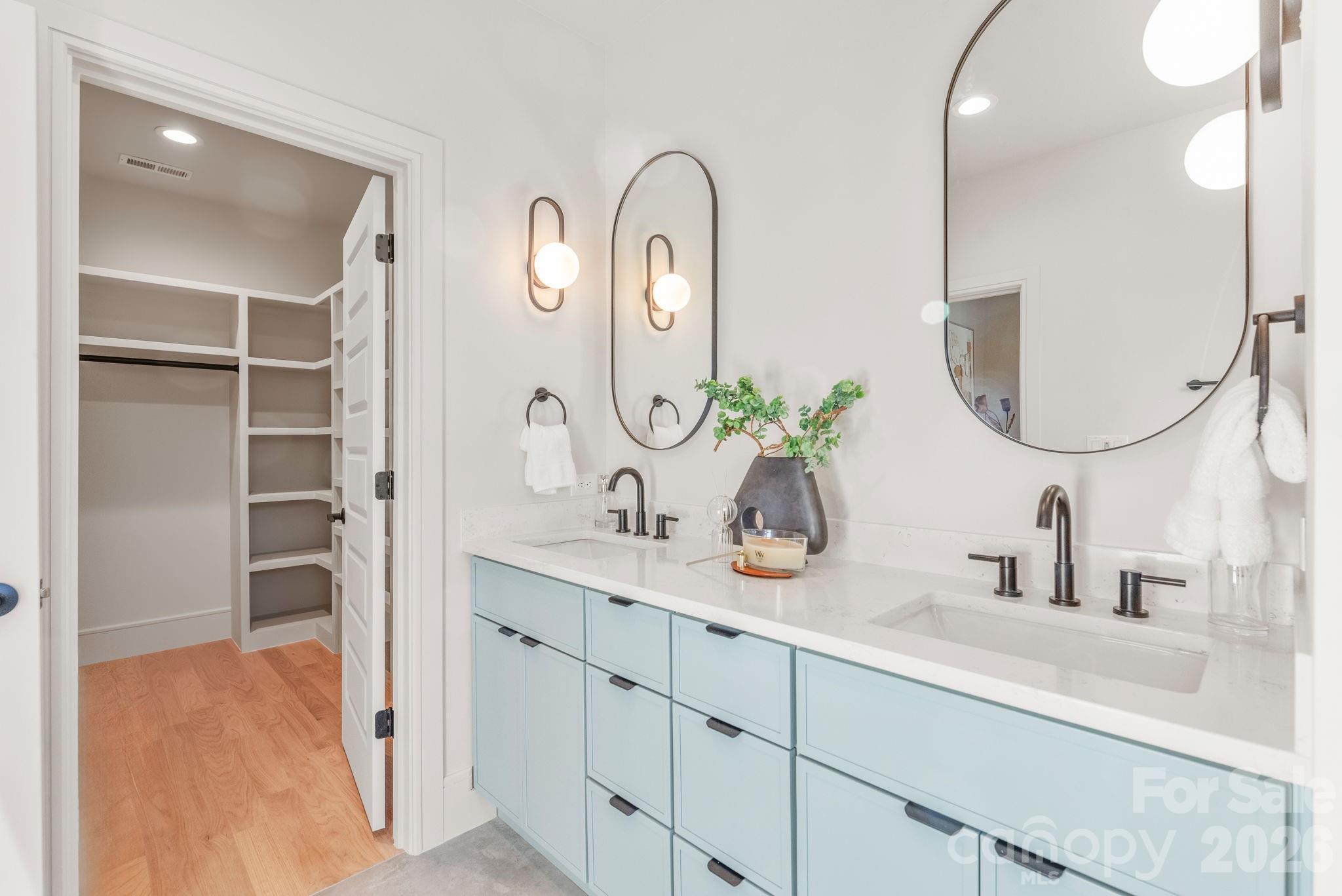 1637 Umstead Street Charlotte, NC 28205 - Photo 33 of 48 a bathroom with a double vanity sink and a mirror