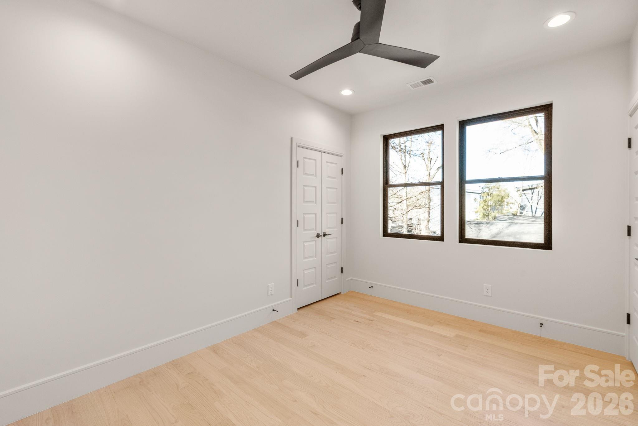 1637 Umstead Street Charlotte, NC 28205 - Photo 35 of 48 an empty room with windows and fan