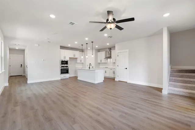 a view of a kitchen with a dishwasher and a stove top oven