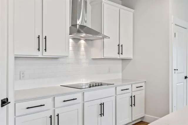 a kitchen with stainless steel appliances white cabinets and a sink