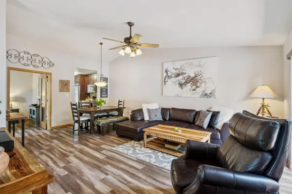 a living room with furniture a rug and a chandelier