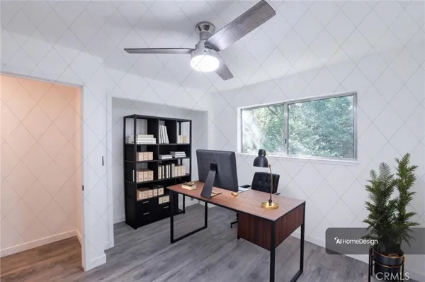 an empty room with wooden floor chandelier fan and windows