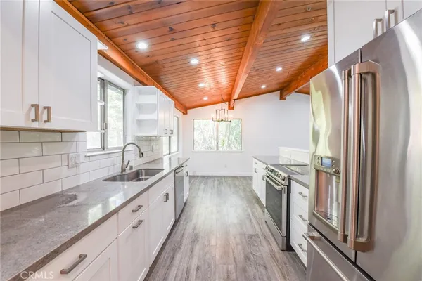 a kitchen with a sink a window and cabinets