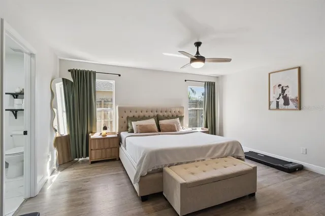 a bedroom with a bed and a chandelier