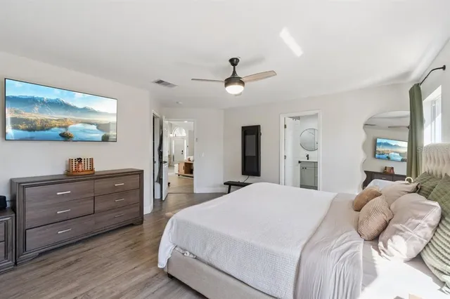 a bedroom with a bed and a flat screen tv