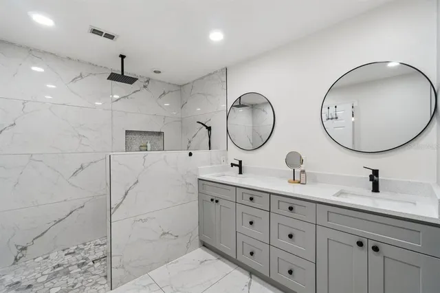 a bathroom with a double vanity sink mirror and double