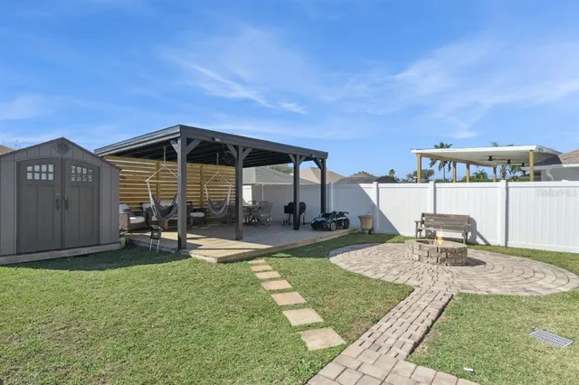 a view of a house with backyard sitting area and swimming pool