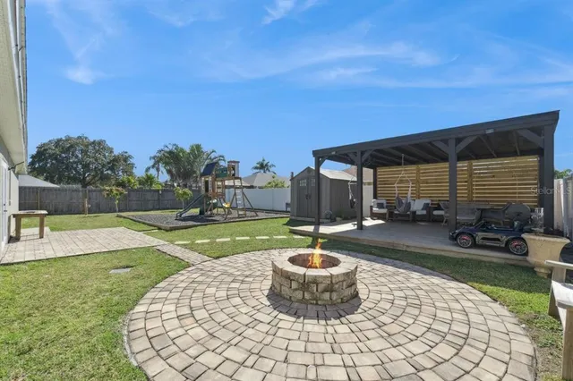 a view of a backyard with swimming pool