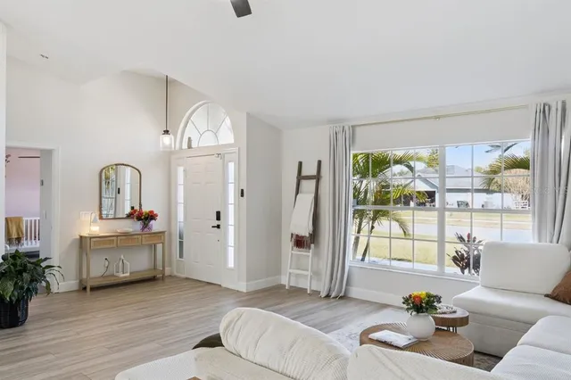 a living room with furniture and a chandelier