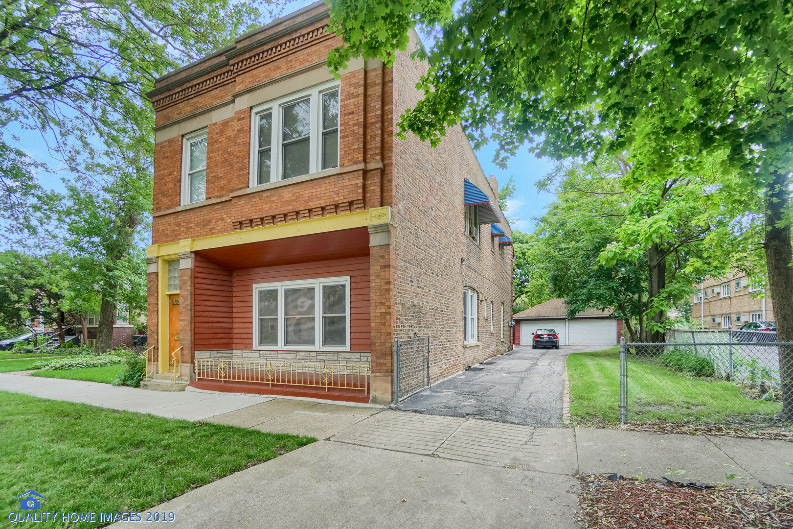 9733 South Charles Street Chicago, IL 60643 - Photo 2 of 26 a front view of a house with a yard and trees