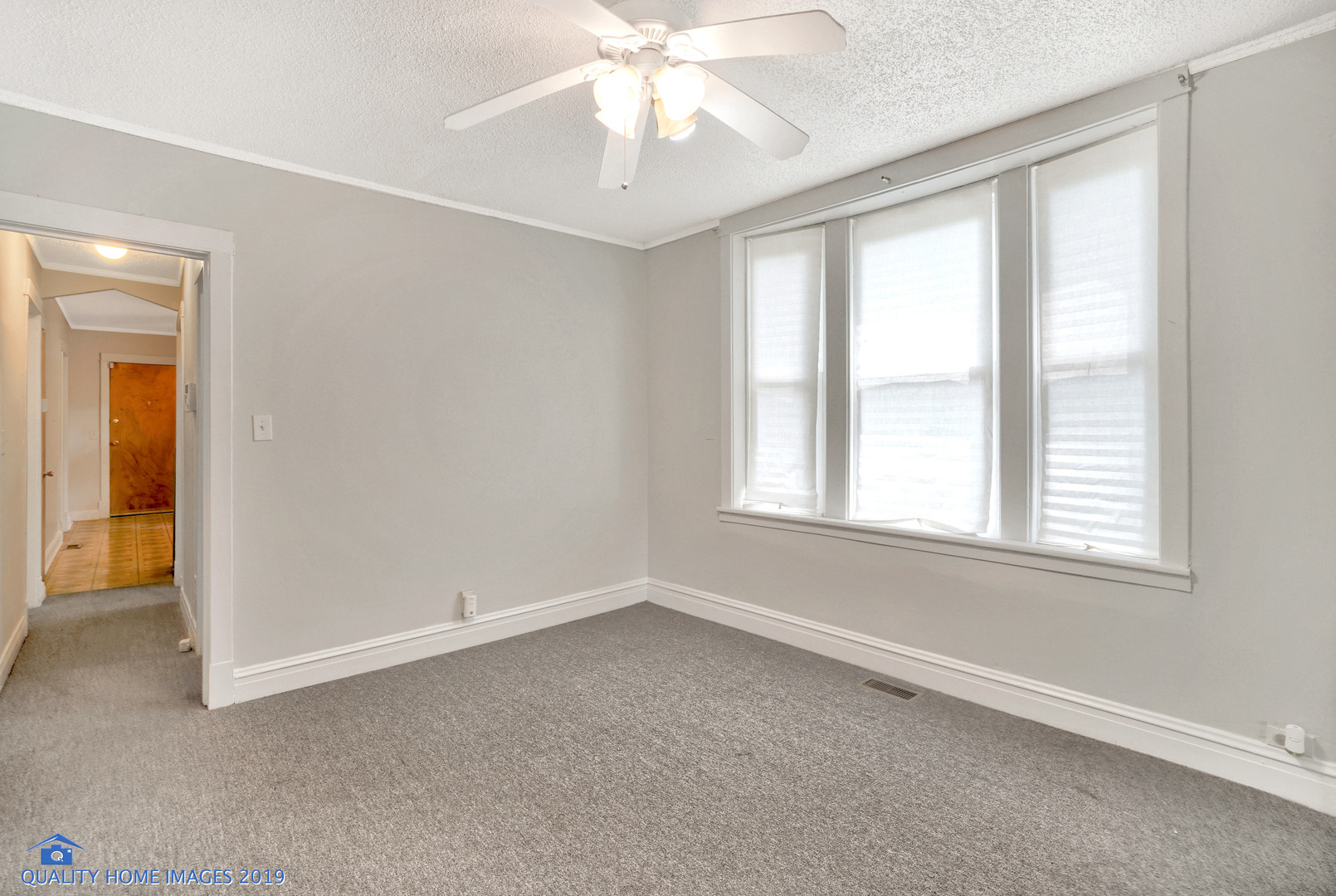 9733 South Charles Street Chicago, IL 60643 - Photo 15 of 26 an empty room with chandelier fan and windows