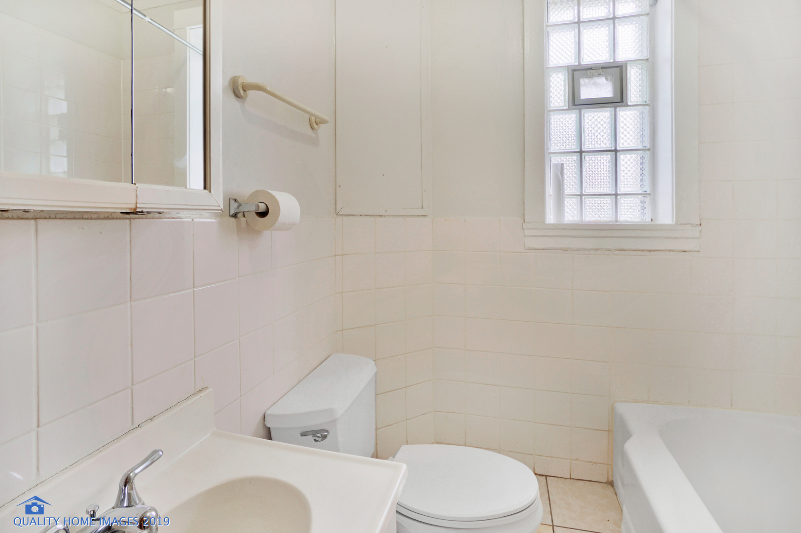 9733 South Charles Street Chicago, IL 60643 - Photo 22 of 26 a white toilet sitting next to a bath tub