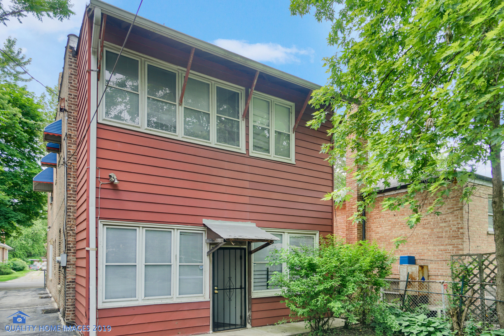 9733 South Charles Street Chicago, IL 60643 - Photo 23 of 26 a front view of a house with a yard and potted plants