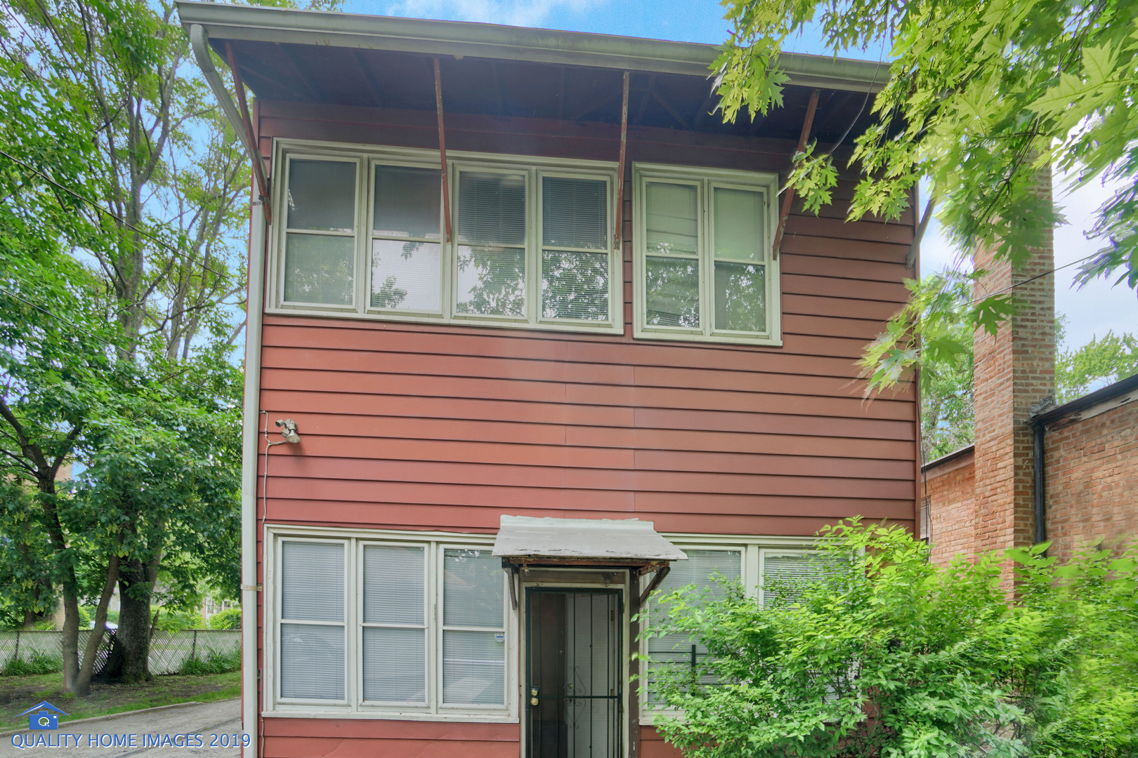 9733 South Charles Street Chicago, IL 60643 - Photo 24 of 26 a front view of a house with plants
