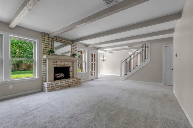 a view of empty room with a fireplace