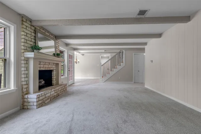 a view of a livingroom with an empty space and a fireplace