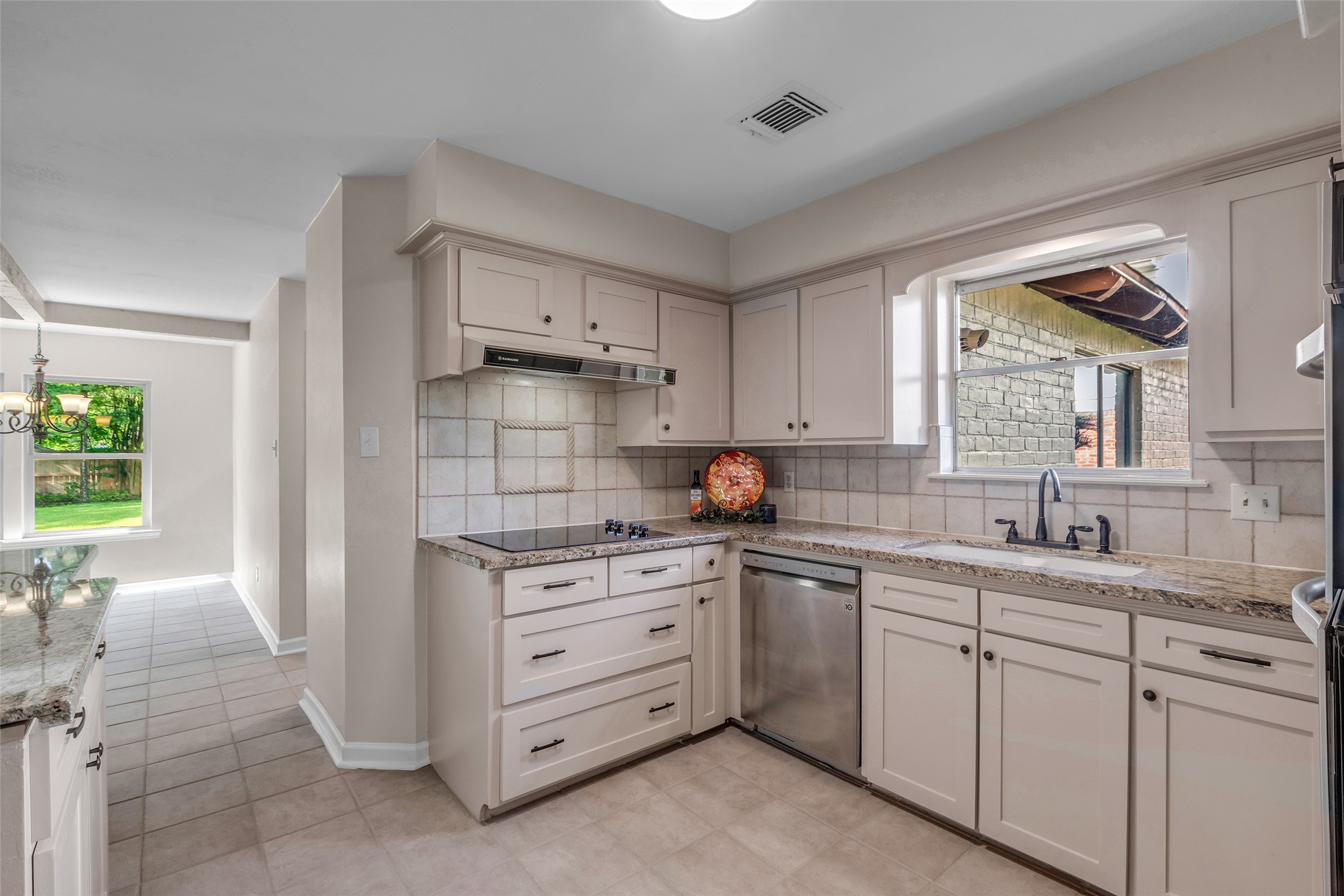 6415 Bayonne Drive Spring, TX 77389 - Photo 20 of 40 a kitchen with a sink stove and cabinets