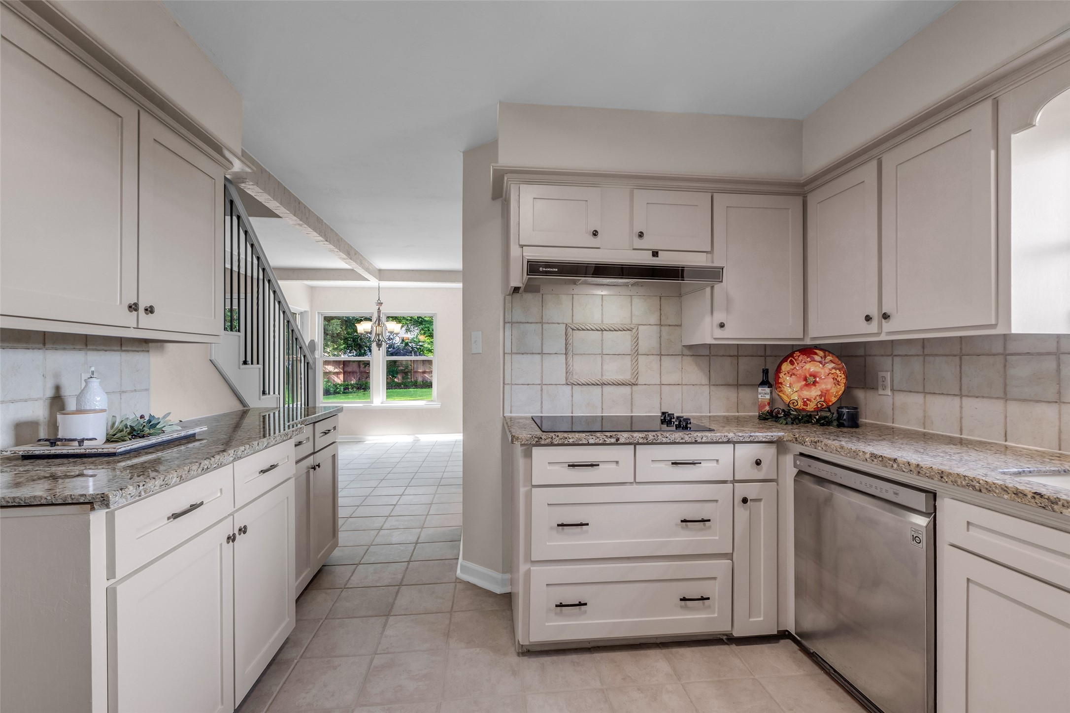 6415 Bayonne Drive Spring, TX 77389 - Photo 21 of 40 a kitchen with granite countertop white cabinets and white appliances