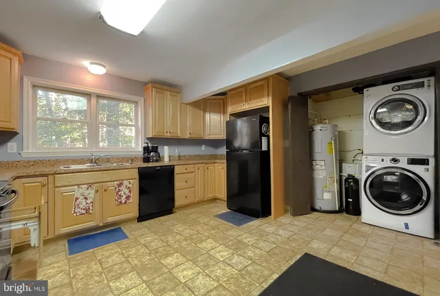 a kitchen with a refrigerator and a stove top oven